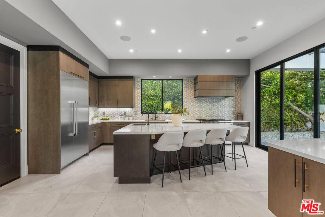 17401 Rancho Street Encino, CA 91316 - Photo 18 of 48 a kitchen with a table and chairs in it