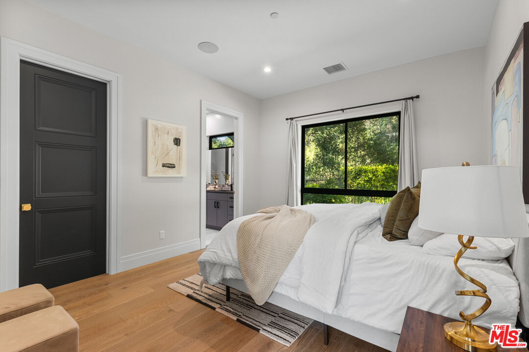 17401 Rancho Street Encino, CA 91316 - Photo 24 of 48 a bedroom with a bed and large windows