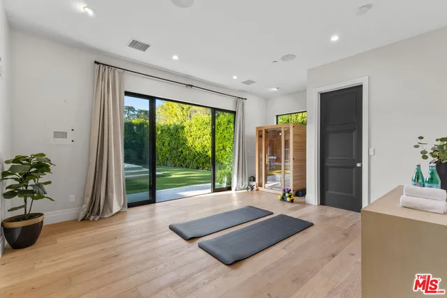 a spacious bedroom with a large window and bed