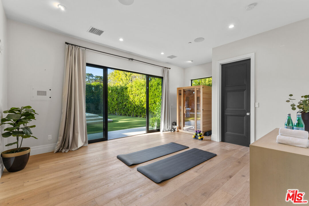 17401 Rancho Street Encino, CA 91316 - Photo 27 of 48 a spacious bedroom with a large window and bed