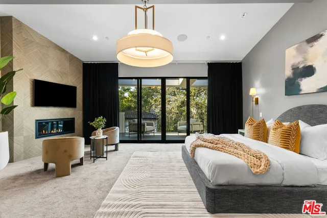 a bed room with a bed and a television