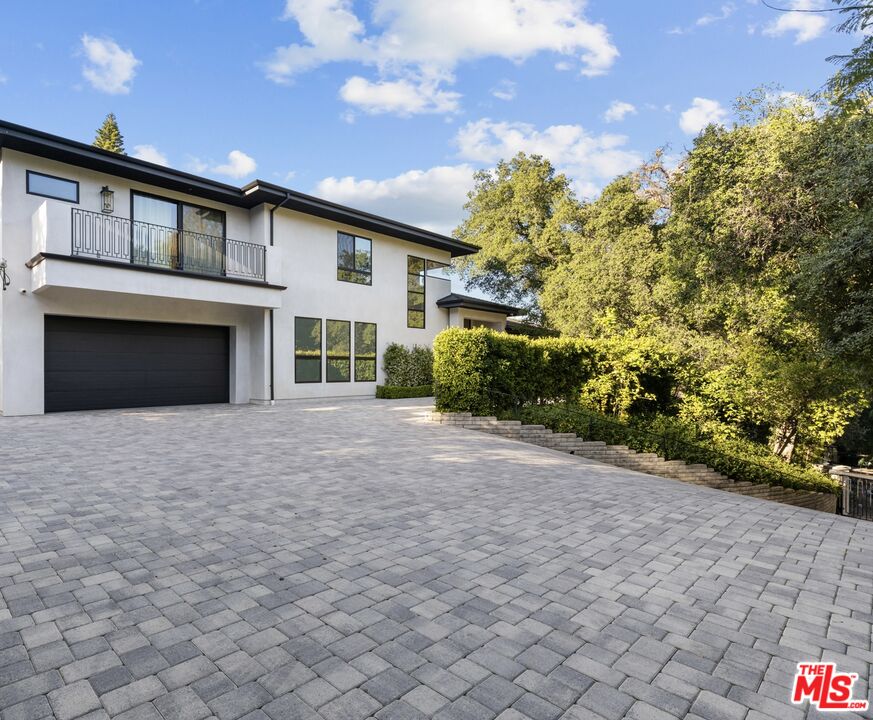 17401 Rancho Street Encino, CA 91316 - Photo 3 of 48 a view of a house with a yard and potted plants
