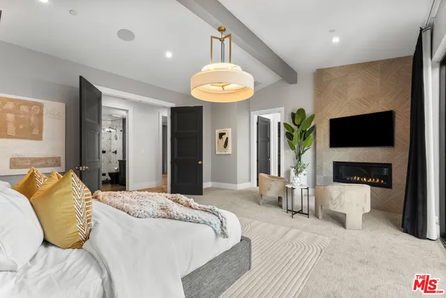 a bedroom with a bed and a flat screen television