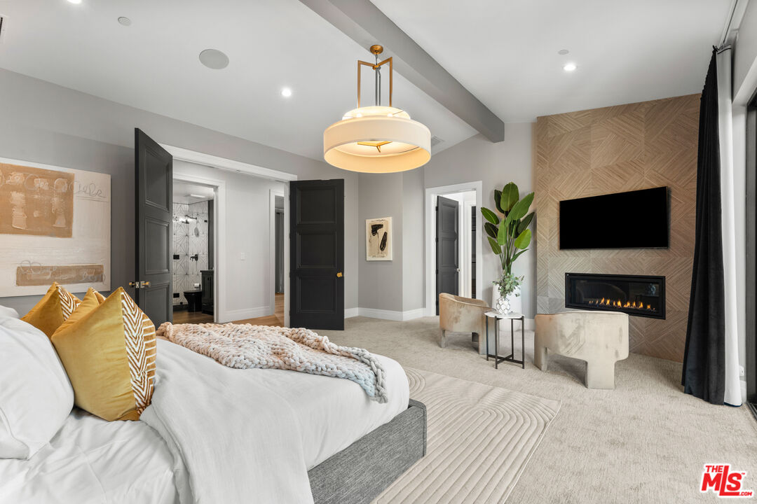 17401 Rancho Street Encino, CA 91316 - Photo 31 of 48 a bedroom with a bed and a flat screen television