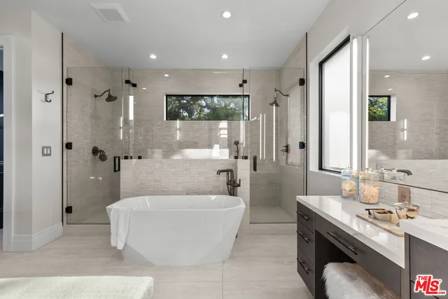 a spacious bathroom with a double vanity sink tub and mirror