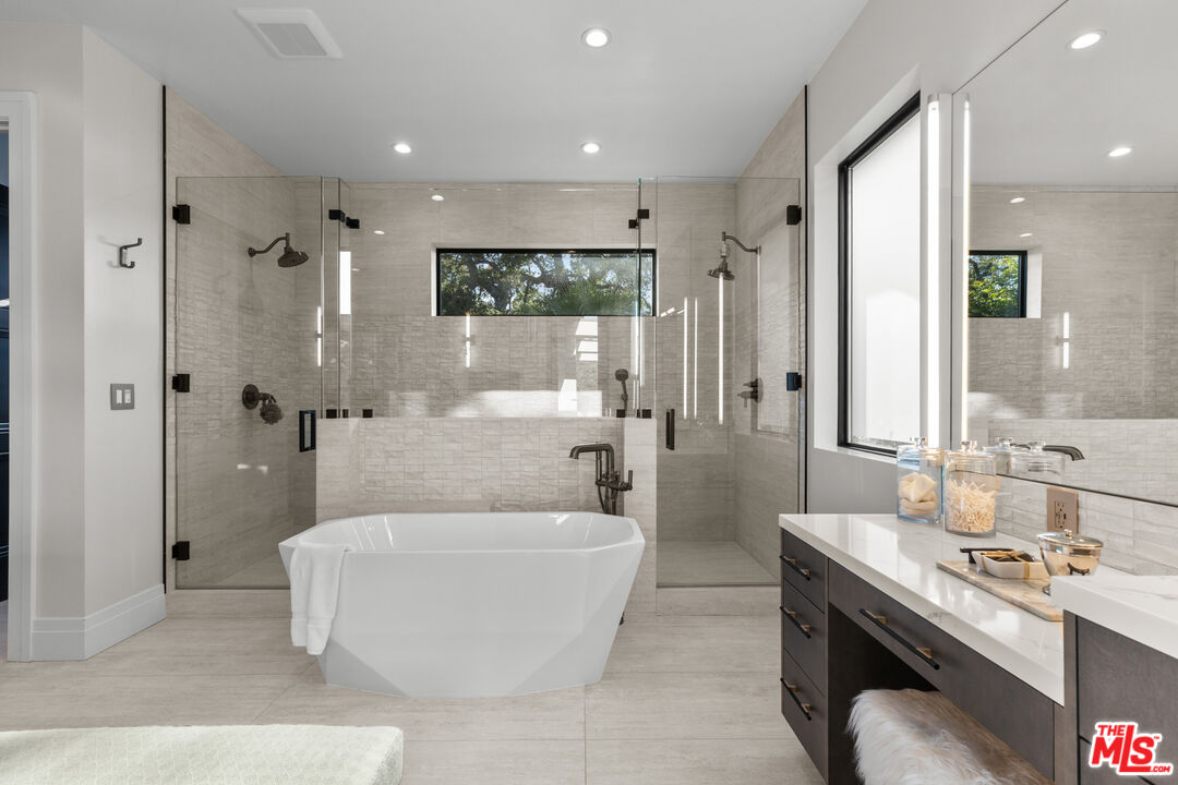 17401 Rancho Street Encino, CA 91316 - Photo 33 of 48 a spacious bathroom with a double vanity sink tub and mirror