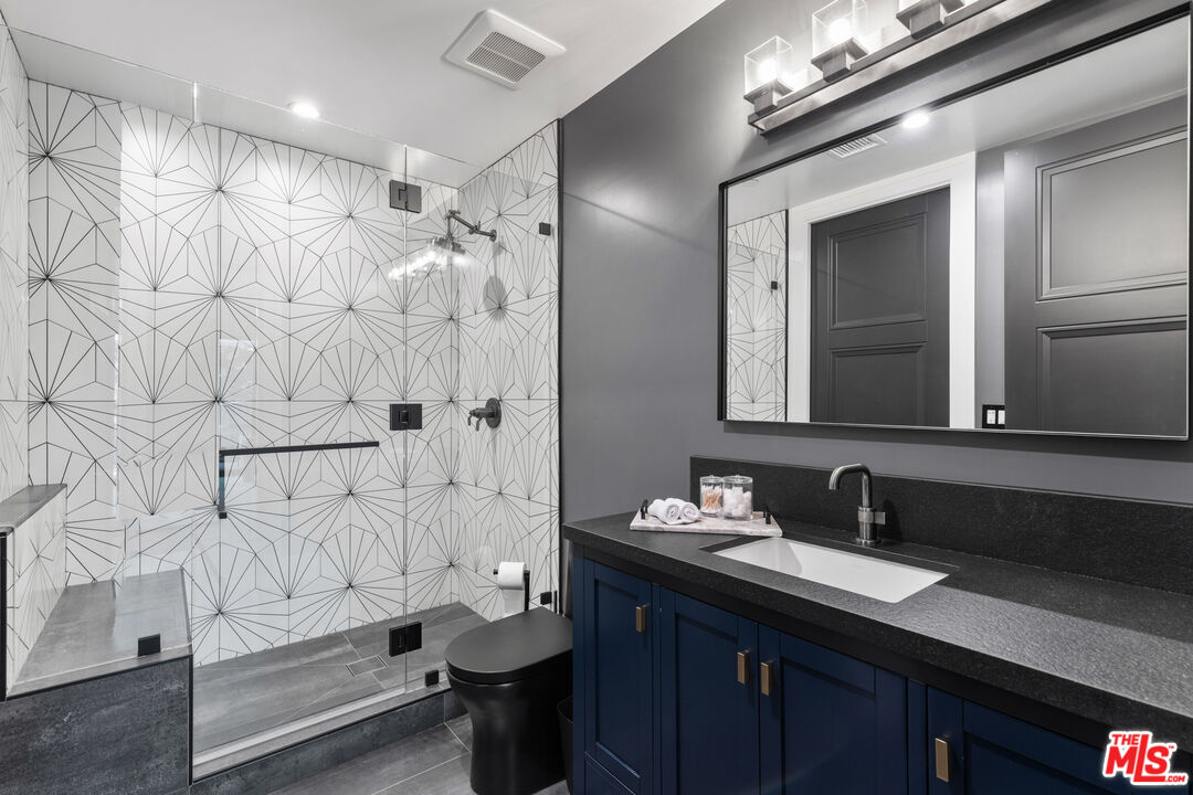 17401 Rancho Street Encino, CA 91316 - Photo 38 of 48 a bathroom with a sink a toilet and shower