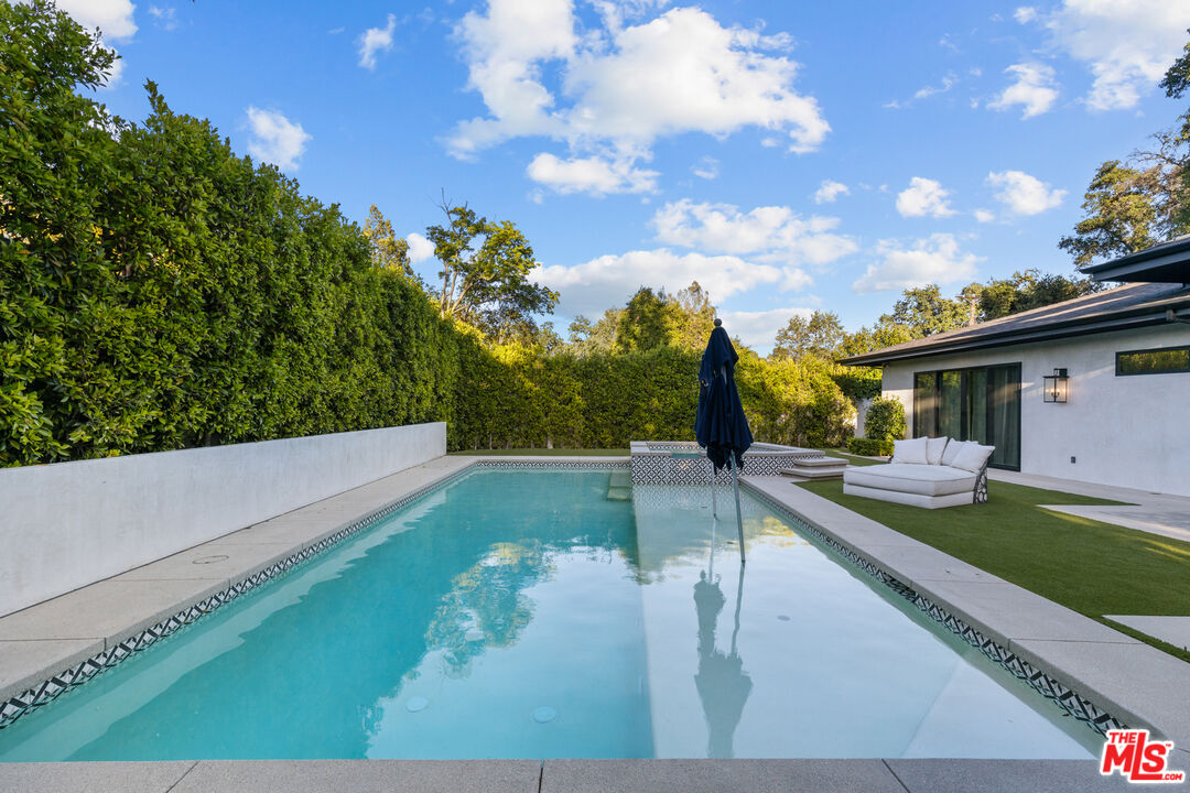 17401 Rancho Street Encino, CA 91316 - Photo 40 of 48 a view of a patio with table and chairs and potted plants