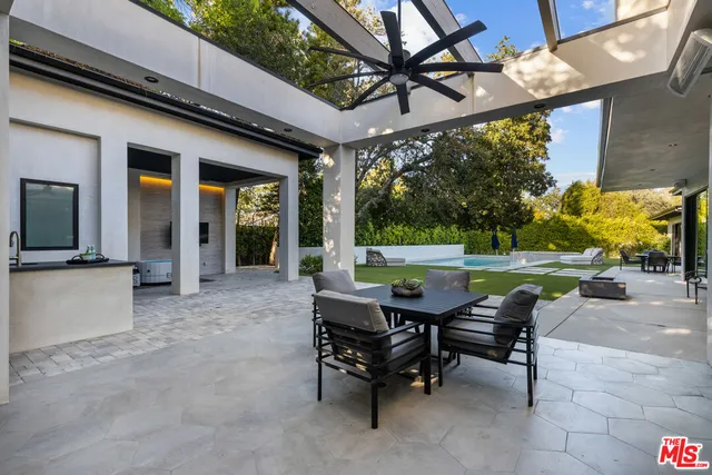 a view of a patio with a table chairs and a backyard