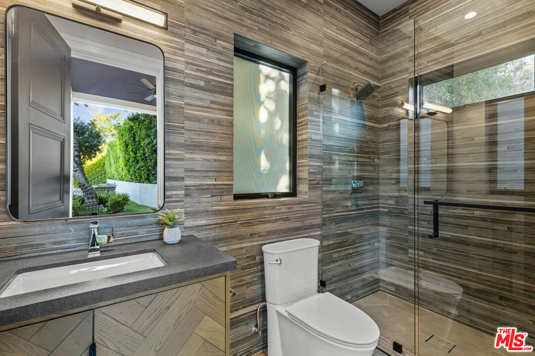 17401 Rancho Street Encino, CA 91316 - Photo 43 of 48 a bathroom with a toilet sink and mirror