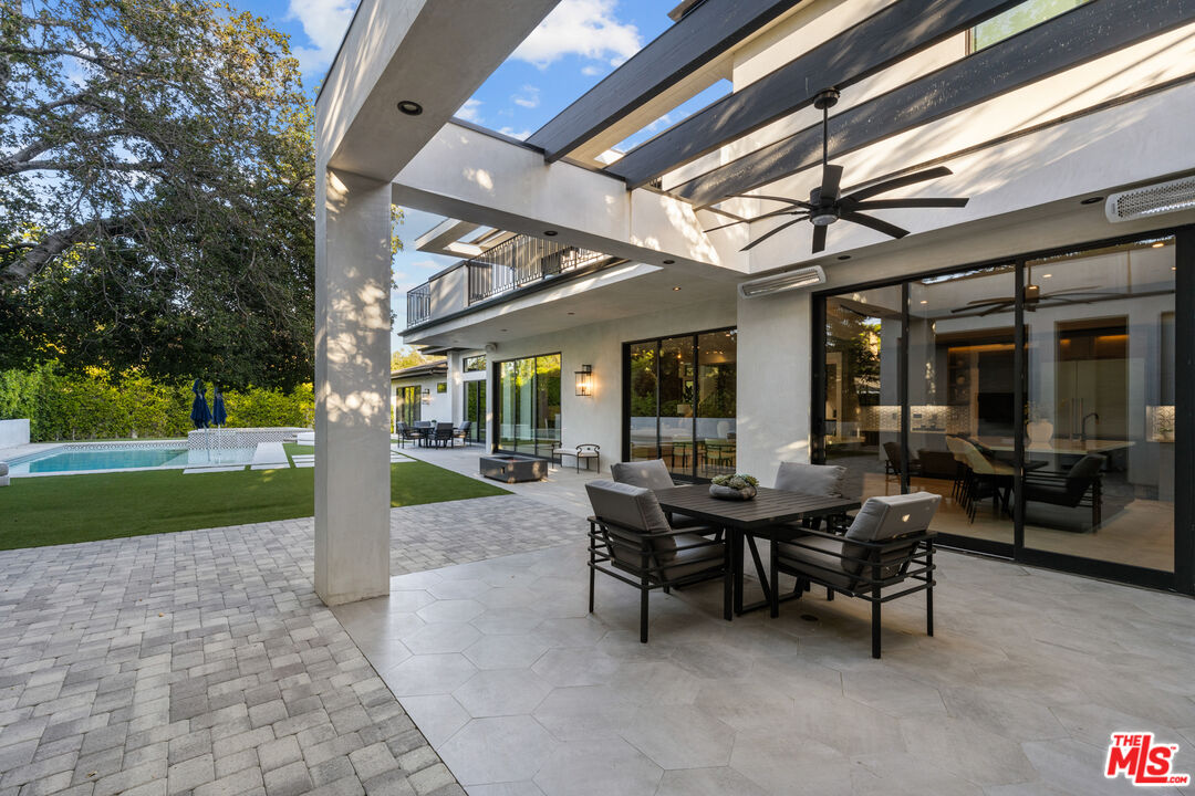 17401 Rancho Street Encino, CA 91316 - Photo 44 of 48 a view of a patio with table and chairs and a large tree