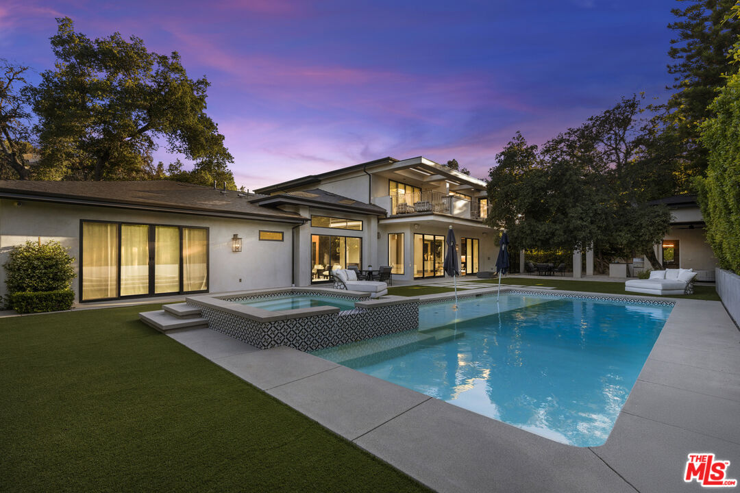 17401 Rancho Street Encino, CA 91316 - Photo 45 of 48 a front view of a house with swimming pool having outdoor seating