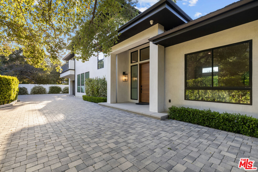 17401 Rancho Street Encino, CA 91316 - Photo 6 of 48 a view of a parking space in a house with a garden