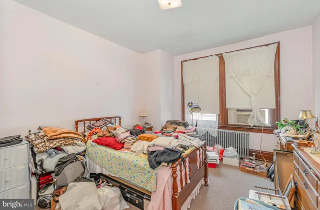 a bedroom with a bed and a shower