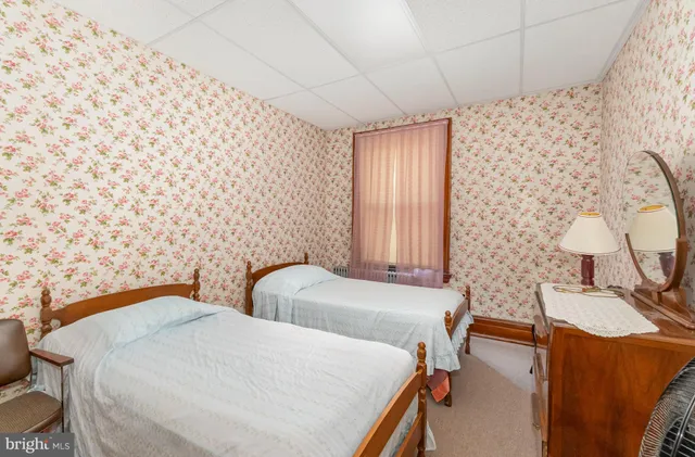 a bedroom with furniture and a window