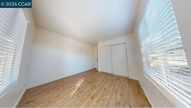 wooden floor in an empty room with a window
