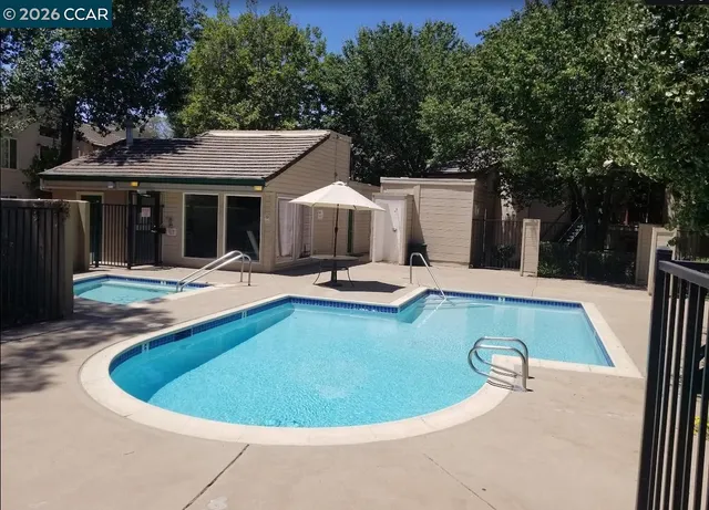 a view of a house with swimming pool and porch