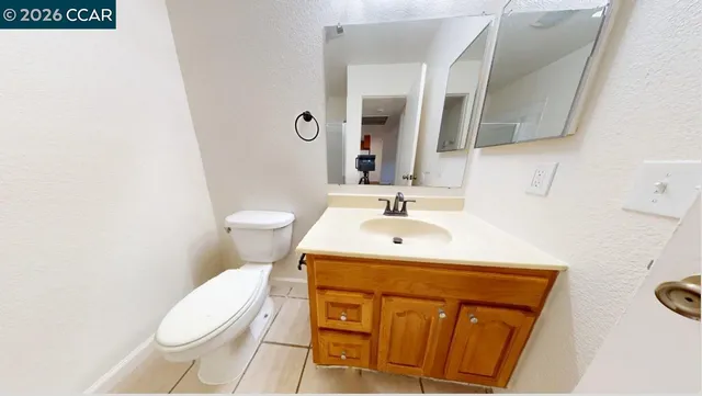 a bathroom with a sink toilet and mirror