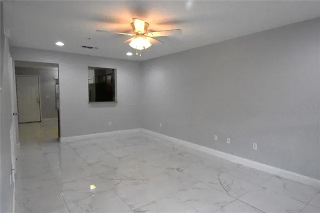 a kitchen with granite countertop a stove a microwave a sink and cabinets