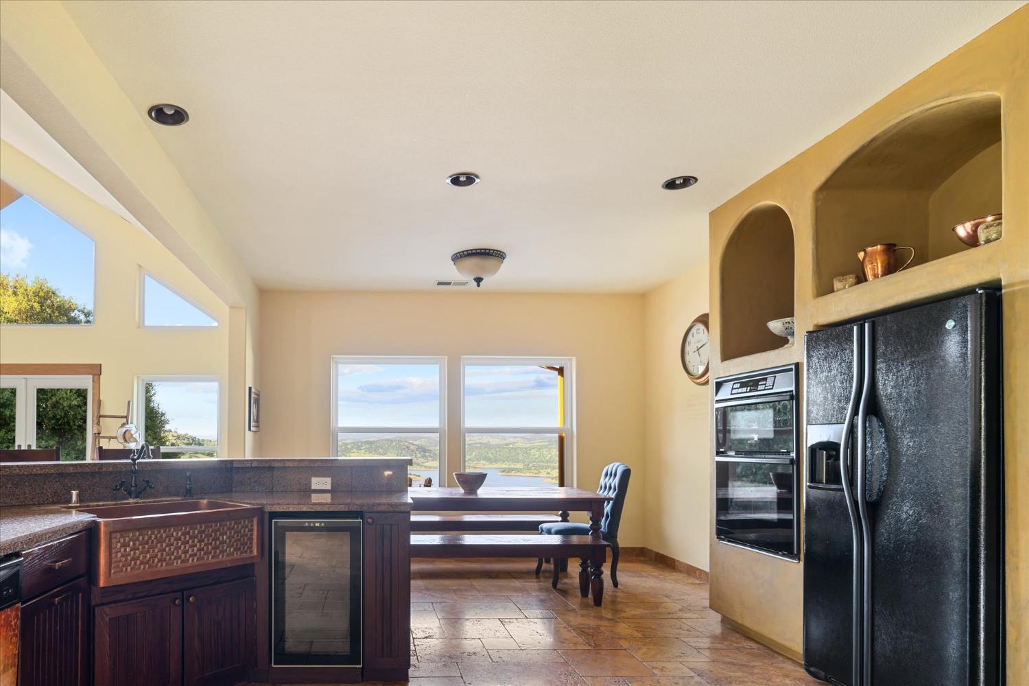 6399 Filly Lane Angels Camp, CA 95222 - Photo 16 of 49 a kitchen with a table chairs refrigerator and cabinets