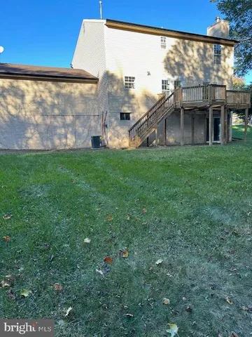 a view of a house with a big yard and large tree