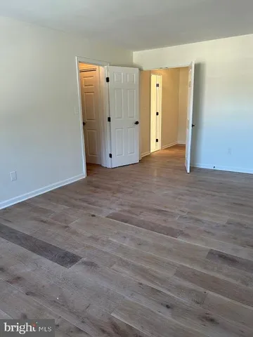 a view of a room with wooden floor