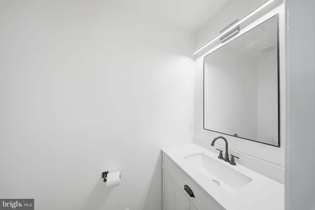 a bathroom with a sink and mirror