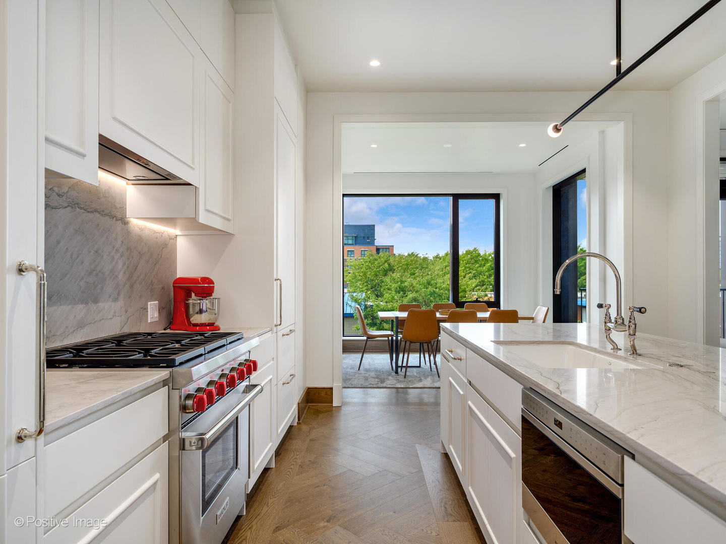 21 North May Street, Unit 505 Chicago, IL 60607 - Photo 13 of 27 a kitchen with a sink stove and cabinets