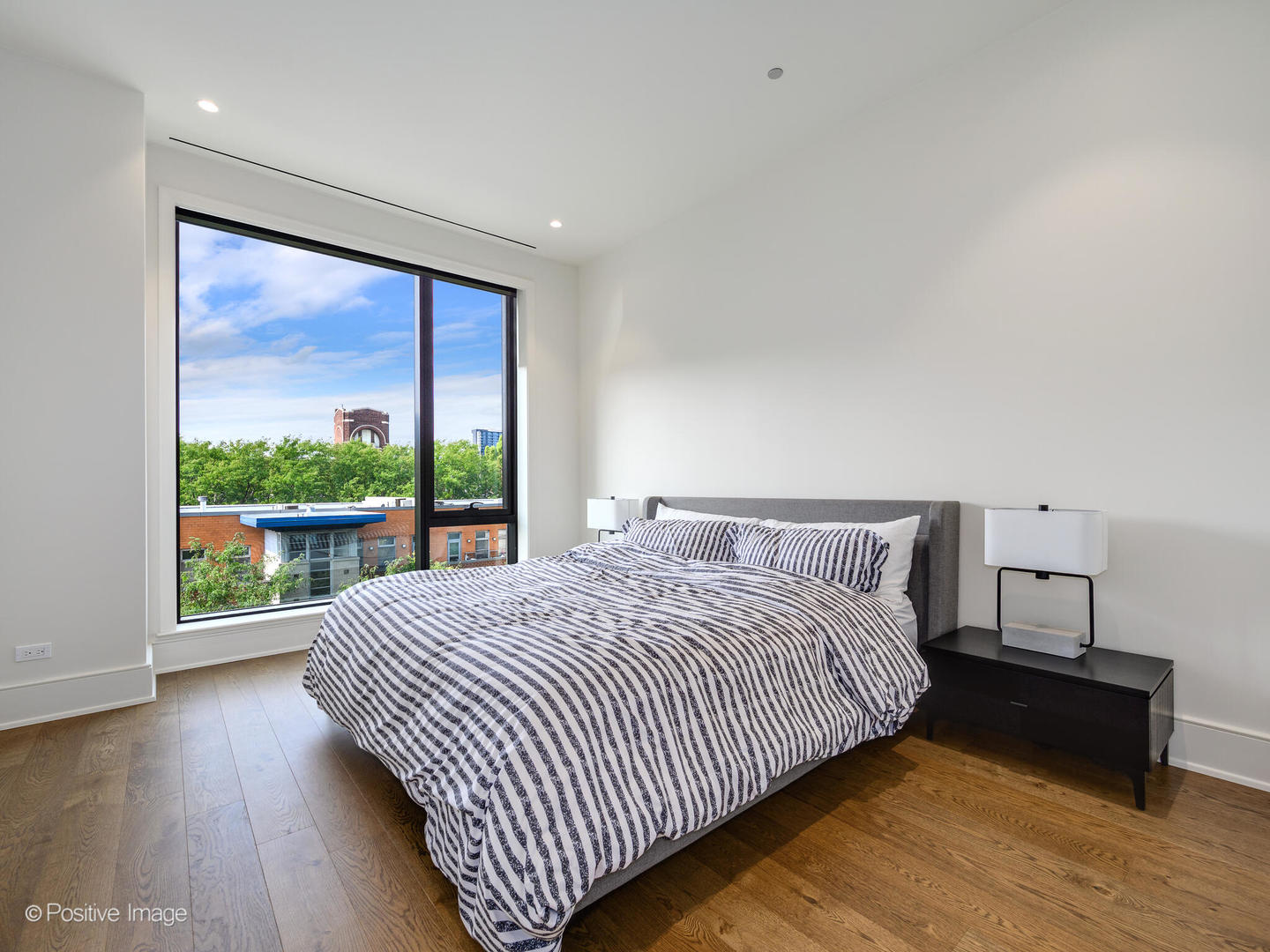 21 North May Street, Unit 505 Chicago, IL 60607 - Photo 19 of 27 a bedroom with a large bed and a large window