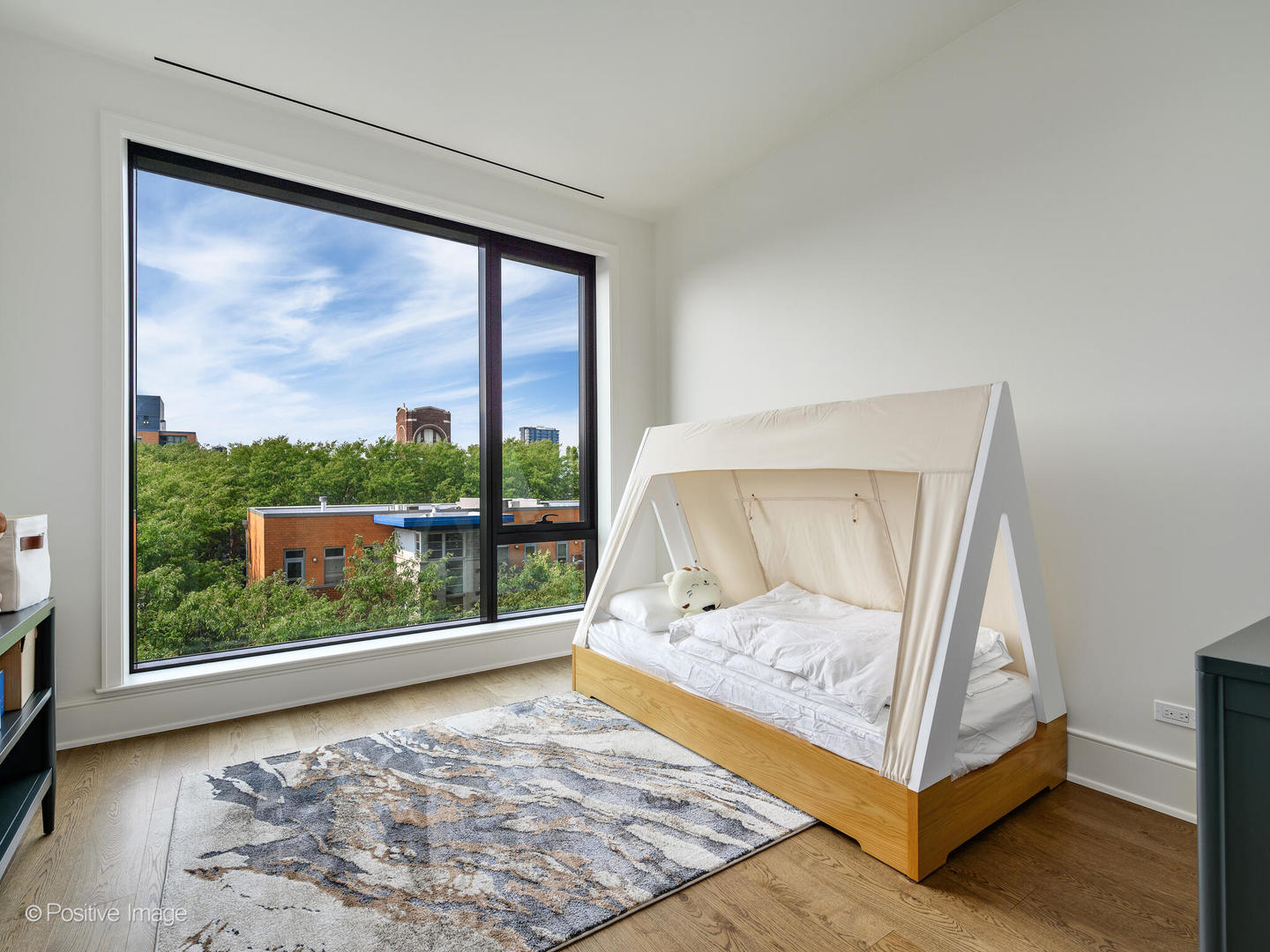 21 North May Street, Unit 505 Chicago, IL 60607 - Photo 24 of 27 a view of a bedroom with wooden floor and a bed