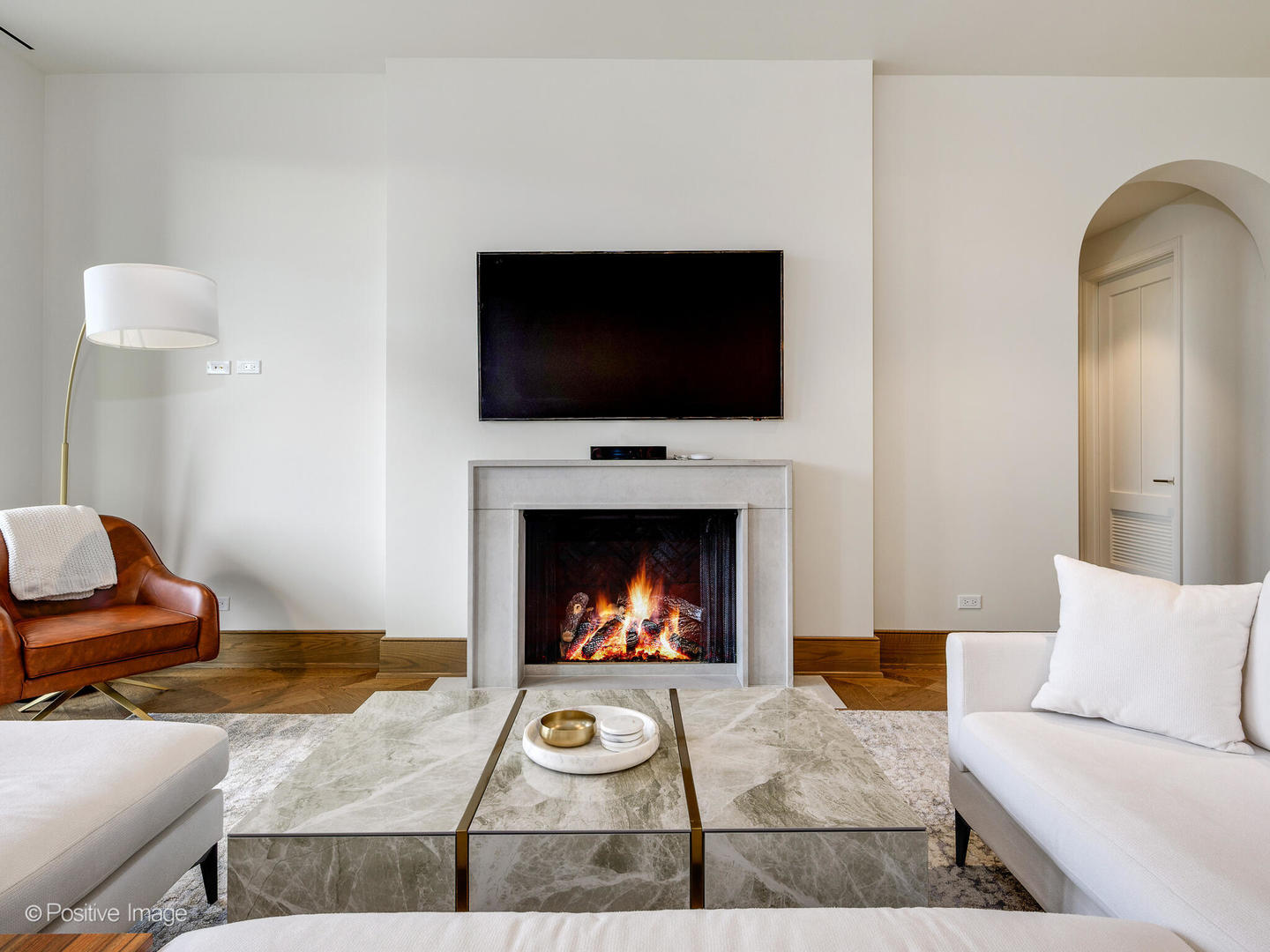 21 North May Street, Unit 505 Chicago, IL 60607 - Photo 7 of 27 a living room with furniture a flat screen tv and a fireplace