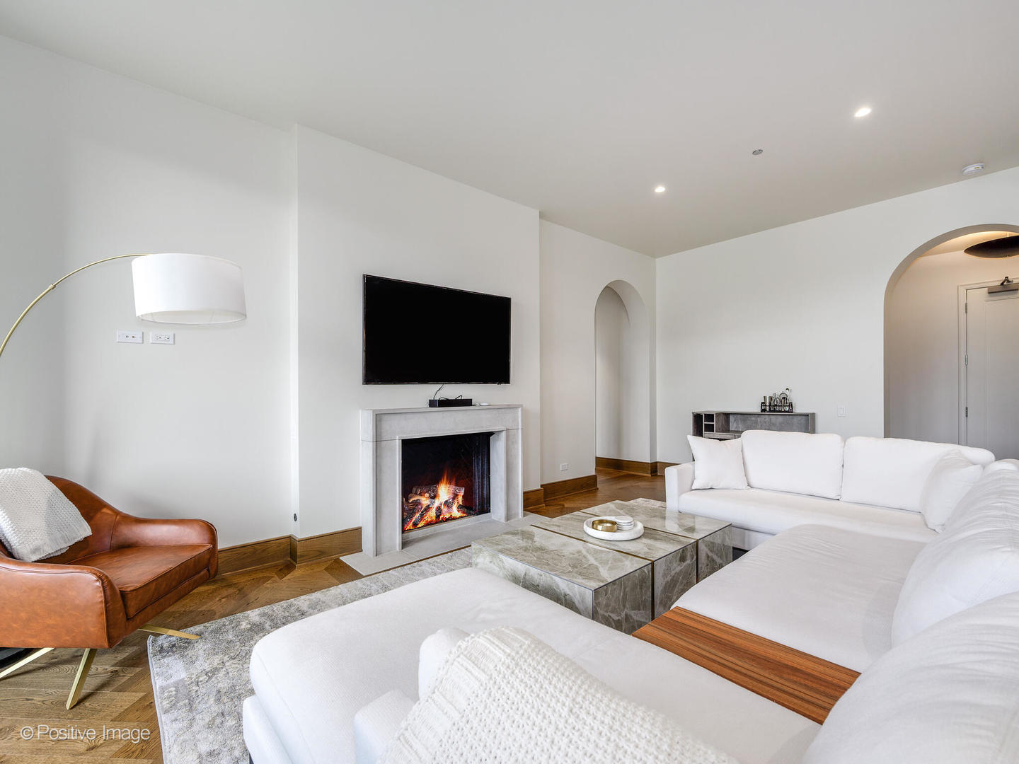 21 North May Street, Unit 505 Chicago, IL 60607 - Photo 9 of 27 a living room with furniture a flat screen tv and a fireplace