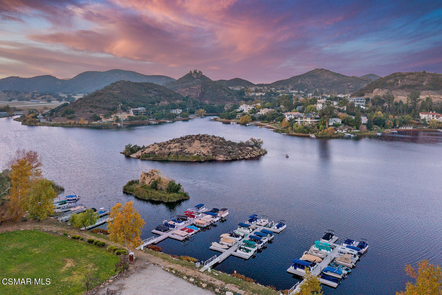 an aerial view of a houses with a lake view