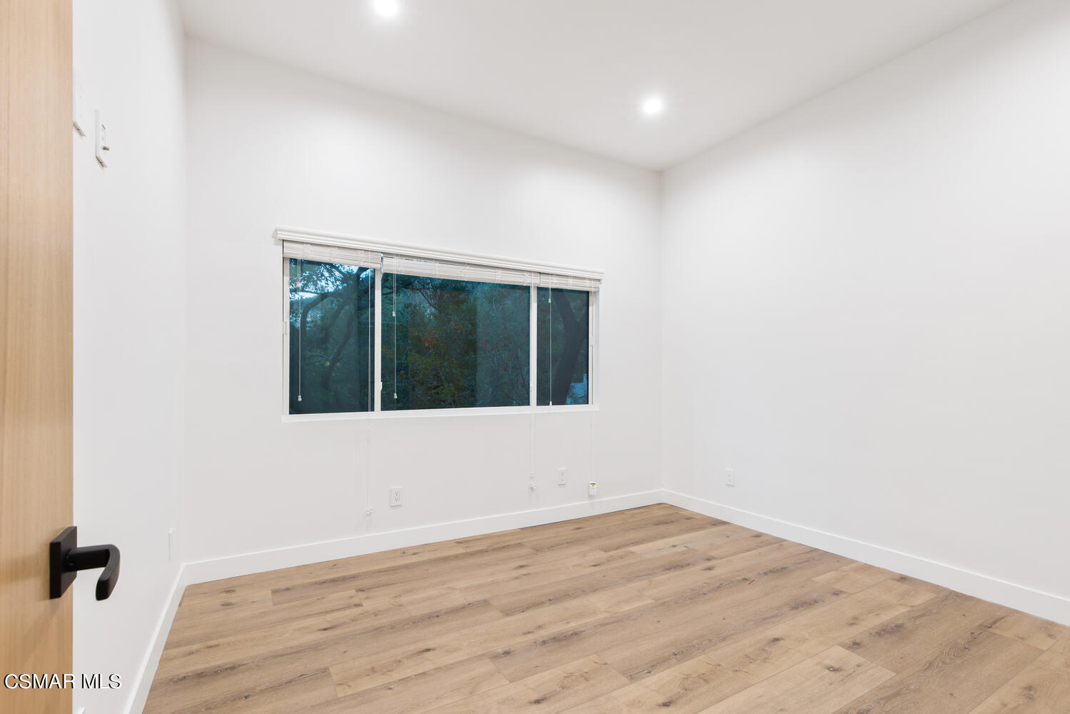 2224 Thorsby Road Lake Sherwood, CA 91361 - Photo 32 of 45 an empty room with wooden floor and windows