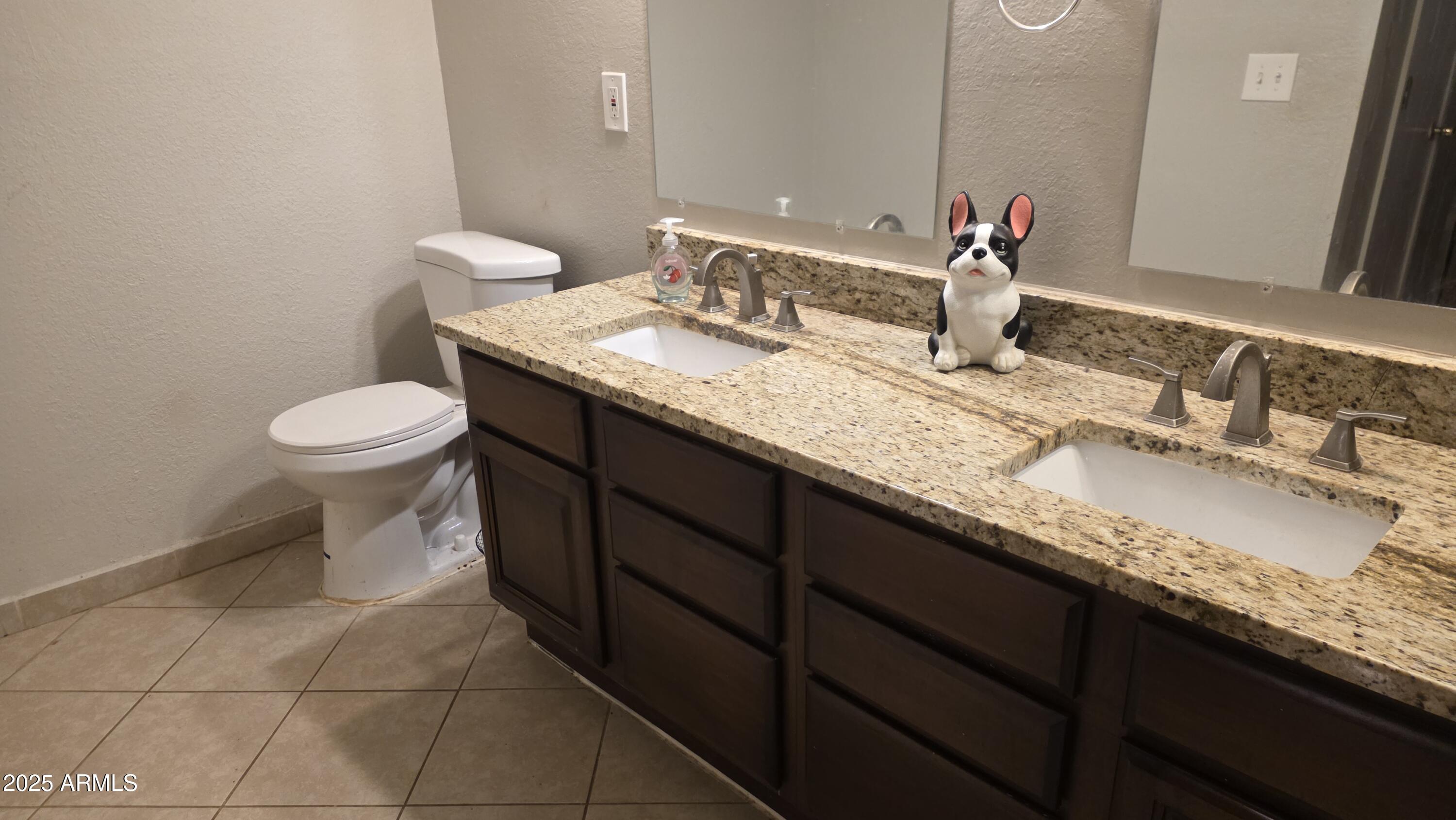 14900 South Capistrano Road Arizona City, AZ 85123 - Photo 13 of 24 a bathroom with a granite countertop sink a toilet and a mirror