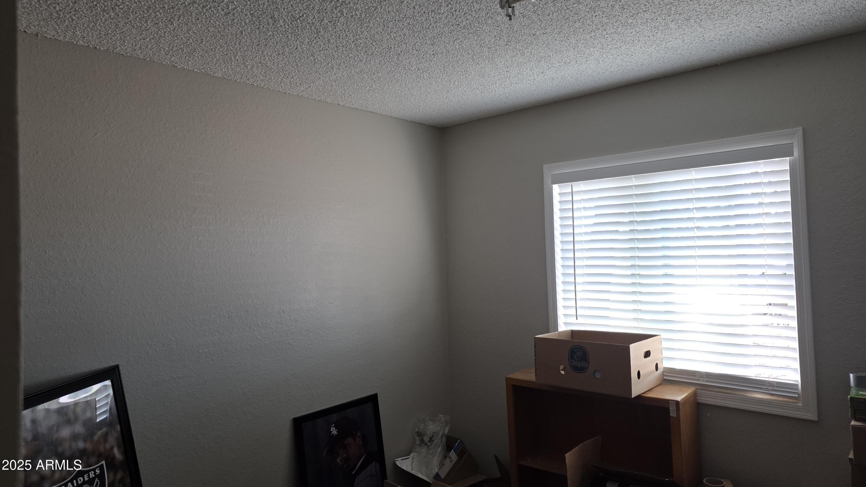 14900 South Capistrano Road Arizona City, AZ 85123 - Photo 18 of 24 a room that has a window and a chair in it