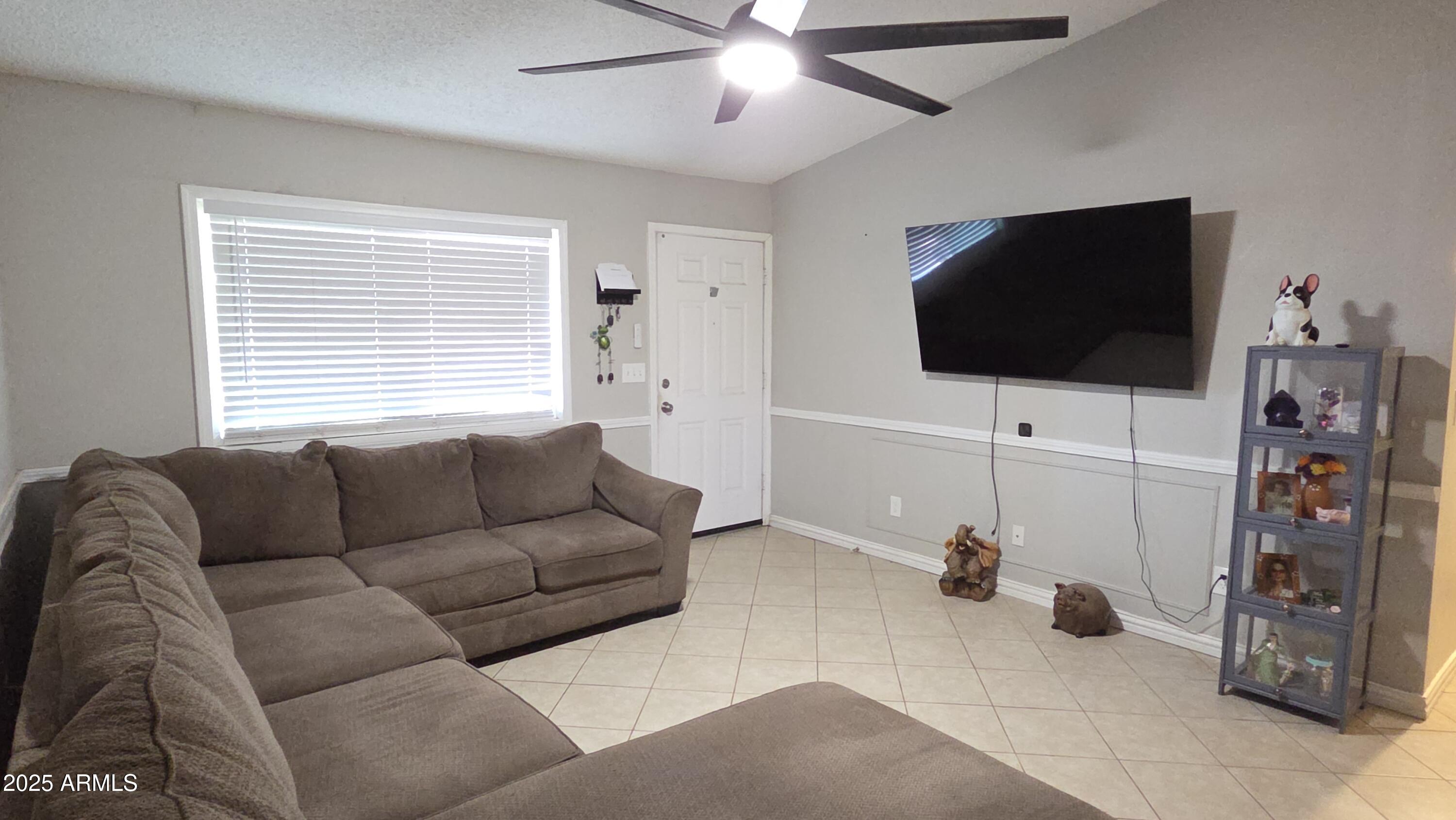 14900 South Capistrano Road Arizona City, AZ 85123 - Photo 3 of 24 a living room with furniture and a flat screen tv