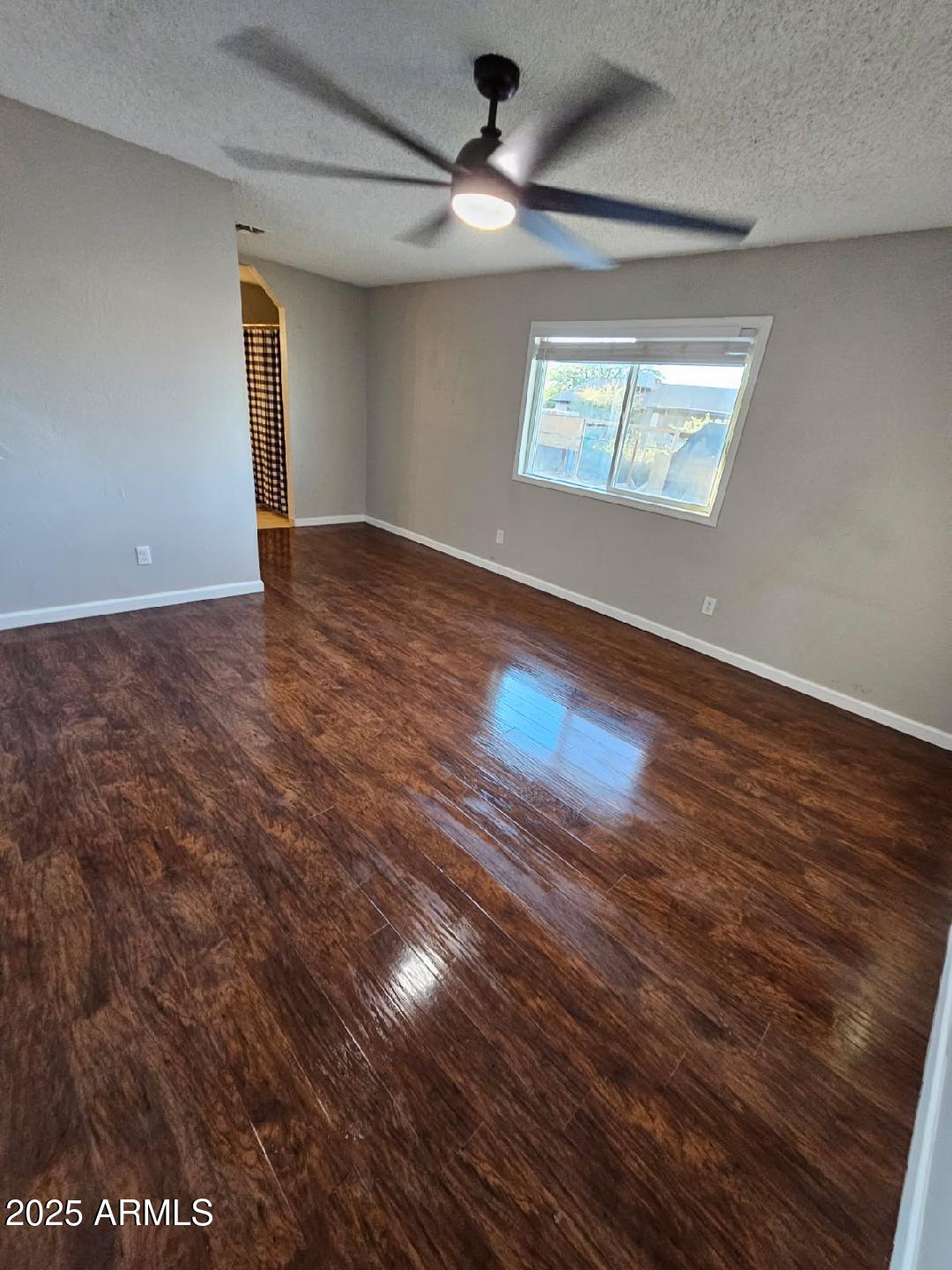 14900 South Capistrano Road Arizona City, AZ 85123 - Photo 5 of 24 an empty room with wooden floor and windows