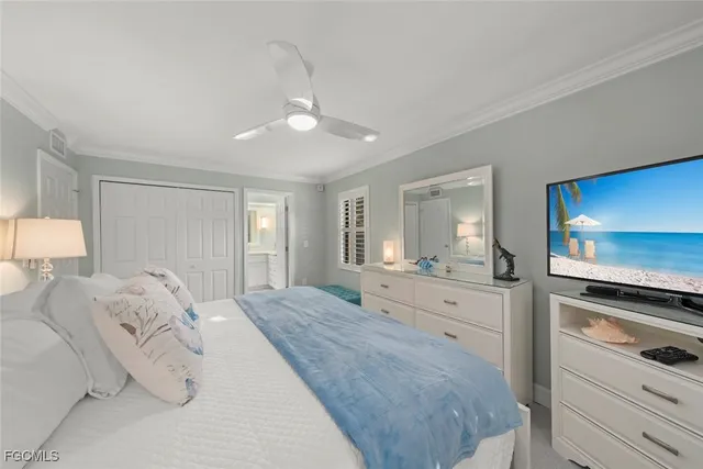 a bedroom with two beds and painting on the wall