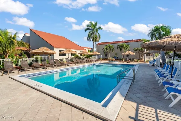 a swimming pool with outdoor seating