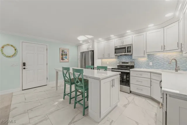 a kitchen with cabinets and chairs