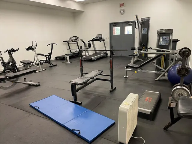 a room with gym equipment and windows