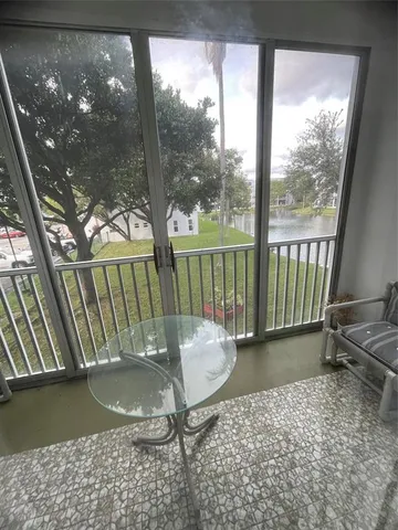 a view of a porch with a table and chairs