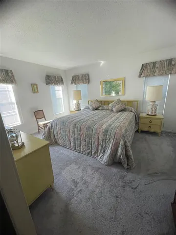 a spacious bedroom with a bed and window