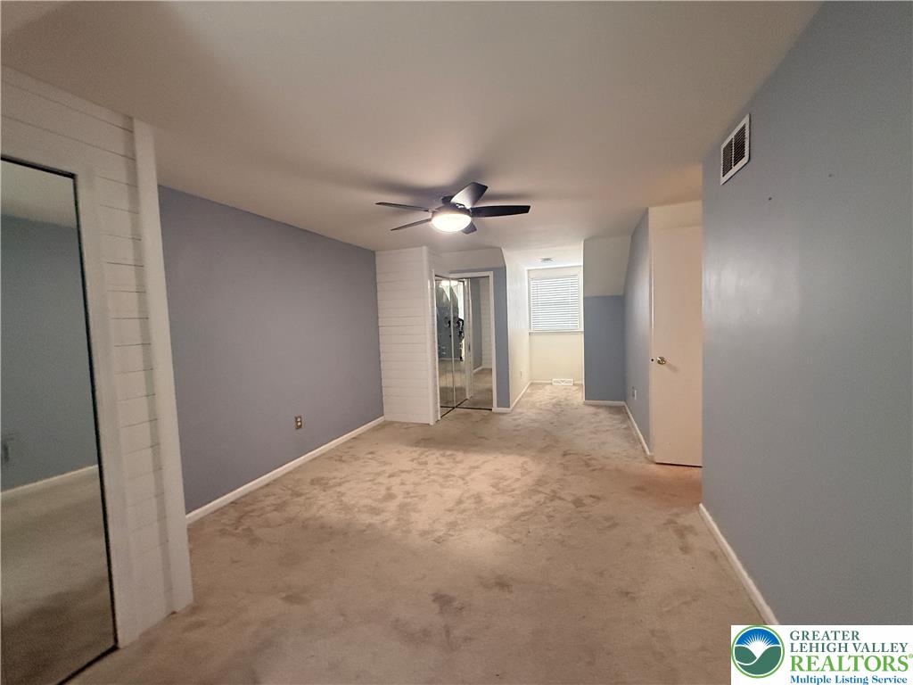 170 Springhouse Road Allentown, PA 18104 - Photo 18 of 23 Well-lit room featuring ample carpeted space and a window with blinds for privacy.