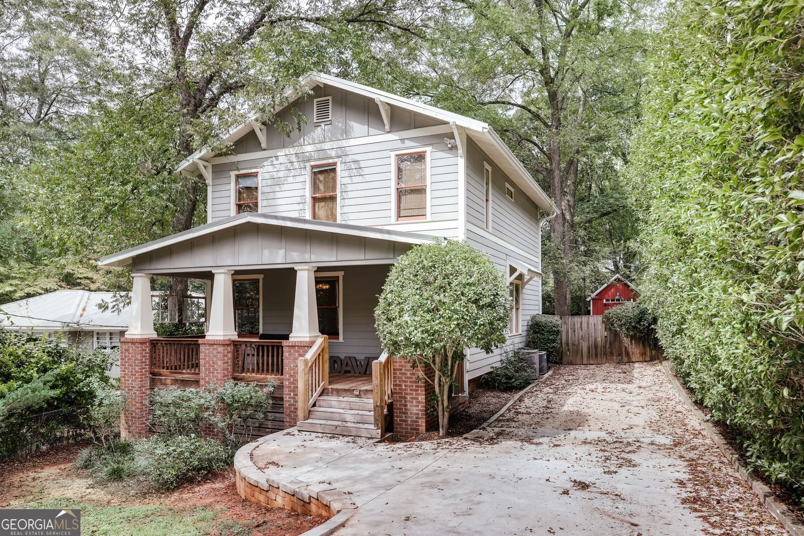 a front view of a house with a yard and trees