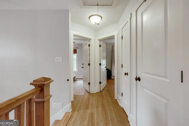 a view of a hallway with wooden floor