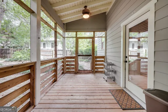 a view of a room with wooden floor and windows