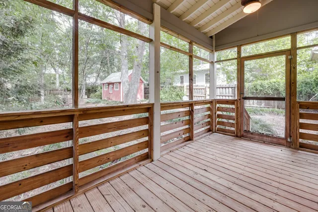 a view of a room with wooden floor and windows