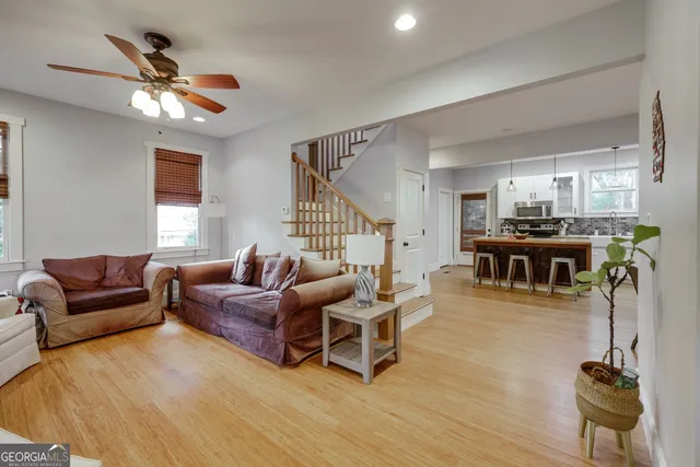 a living room with furniture and kitchen view